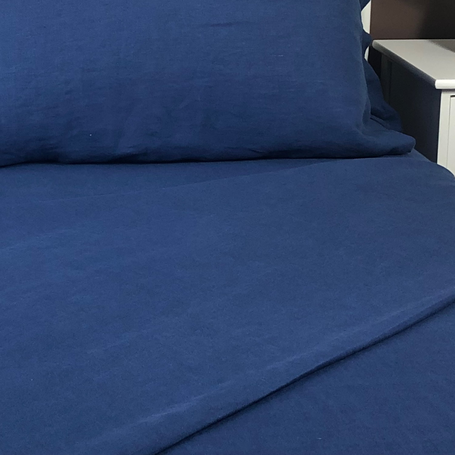 Close up of Atlanta Colours linen blue flat sheet